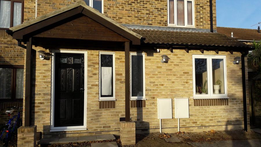 Yellow brick front elevation with a timber framed porch